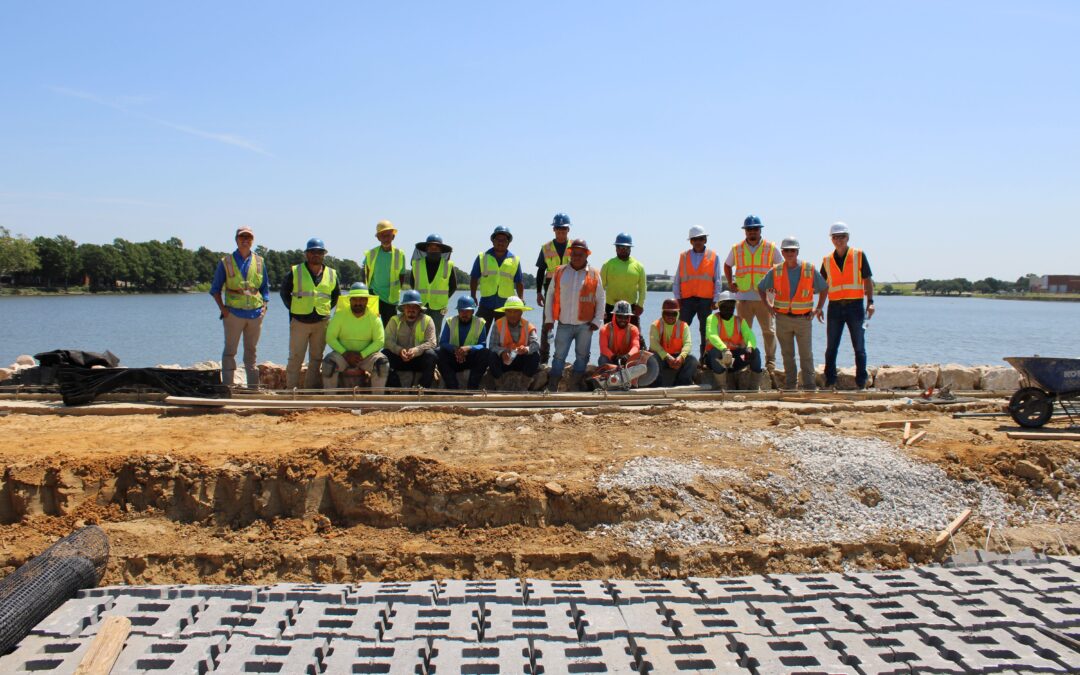 The Bachman spillway construction workers pose on the spillway July 2025